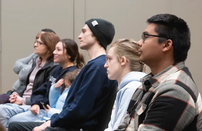 Group of students sitting in the audience at an event.